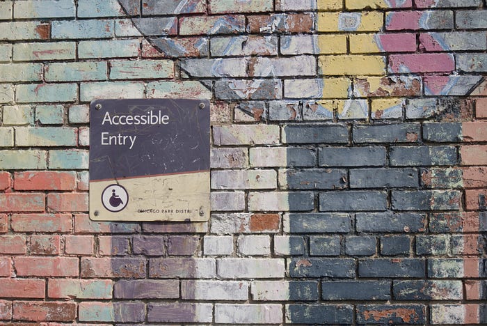 a wall featuring an accessibility sign