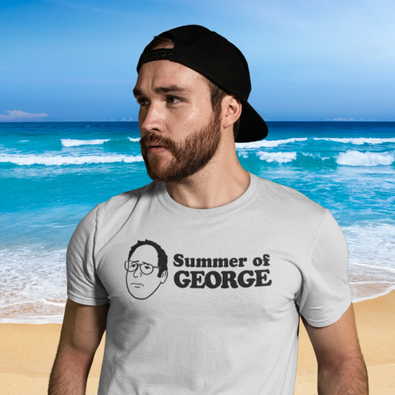 man on a beach wearing a summer of George t-shirt